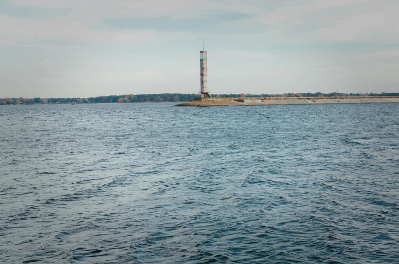 an industrial structure sitting in the middle of a lake