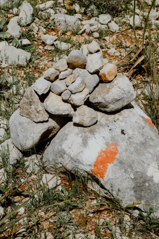 a pile of rocks are piled high on a rocky field