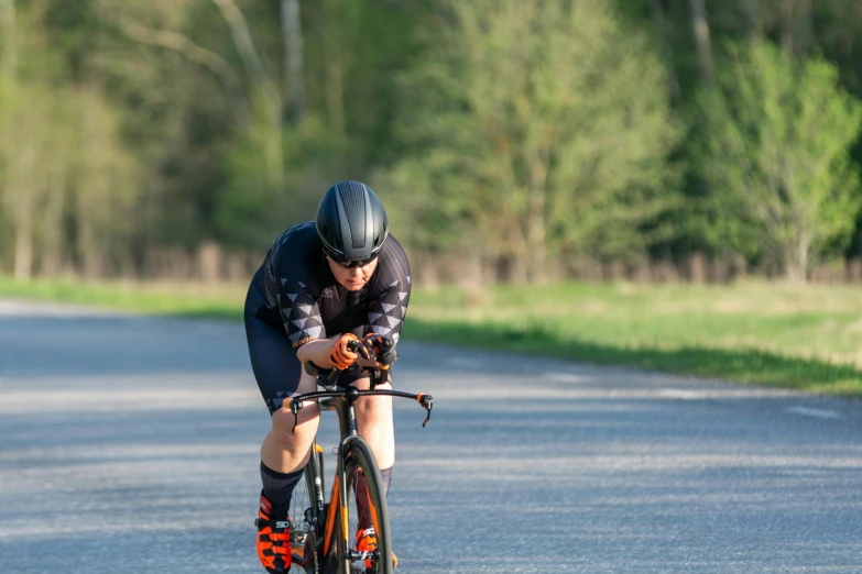 a man riding on the back of a bike down a road