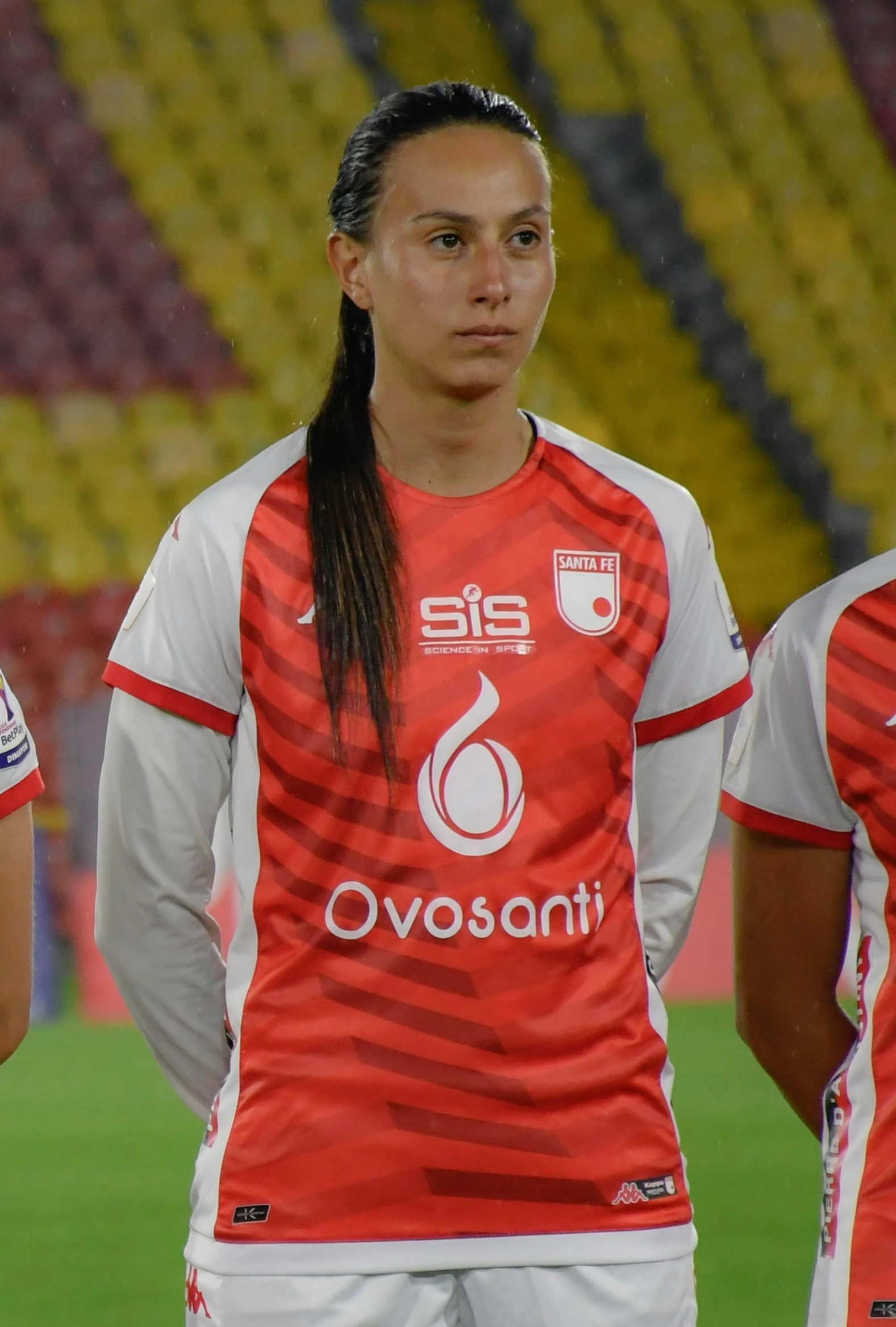 two female soccer players pose for a po