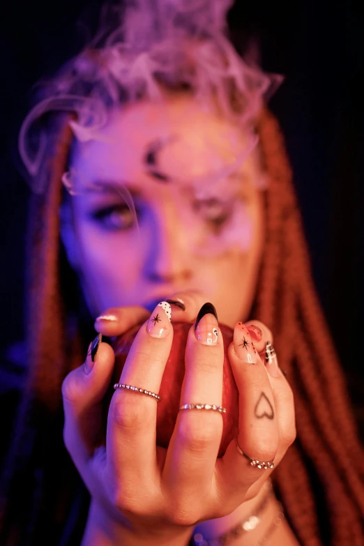 a woman holding a cigarette while smoking a cigarette