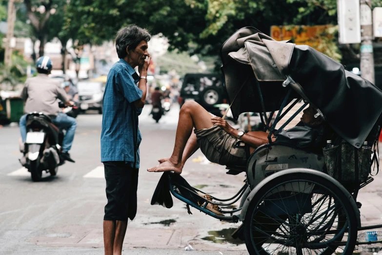 a man standing by a parked bicycle with a child strapped to it