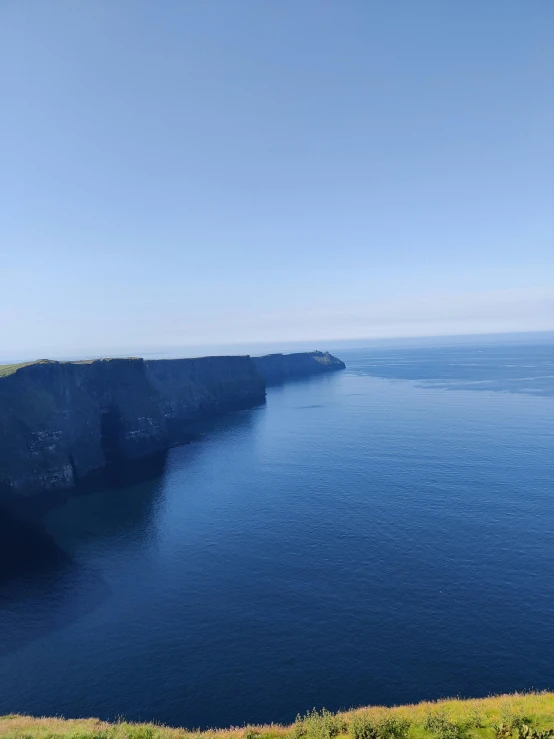 a hill with water in the middle and cliffs on top