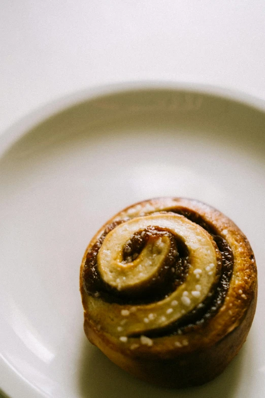 a pastry is displayed on a plate in a dark color