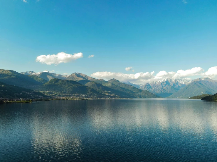 water in the mountains with clouds over them