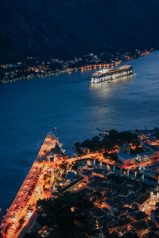 a city street with a boat floating on the water at night