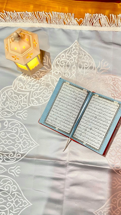 a book and candle on the ground with an intricate design on it