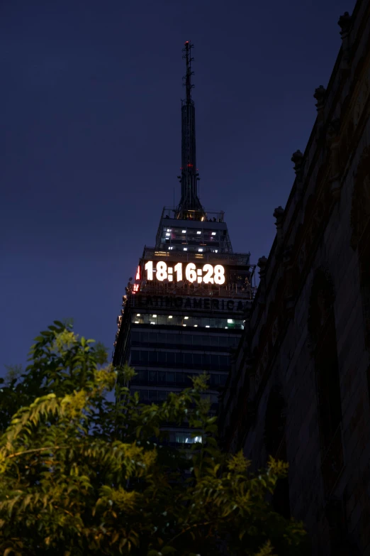 a view of a tall building with the moon in the sky