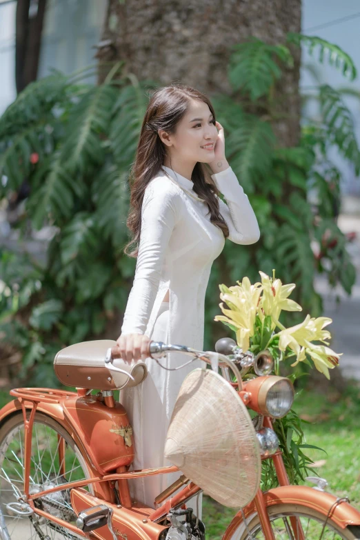 a woman is standing next to a bicycle