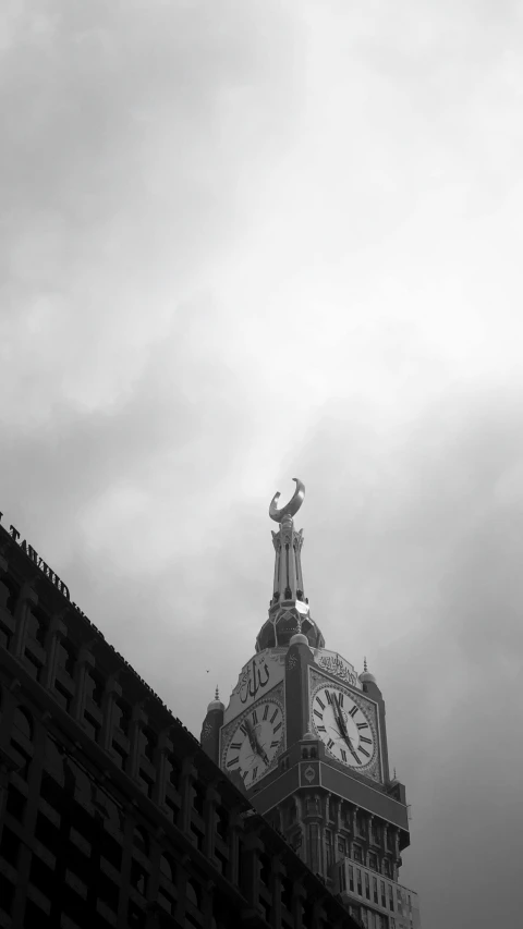 a black and white po of the top of a building with a clock