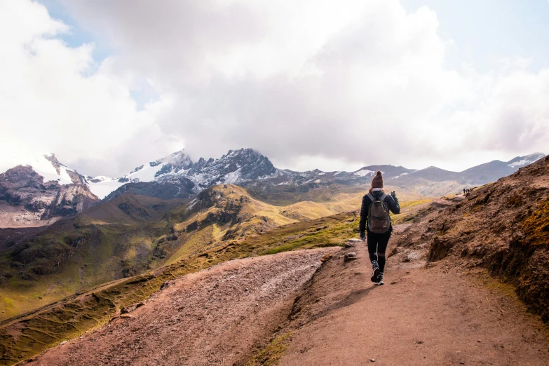 a person walking in the mountains along a trail