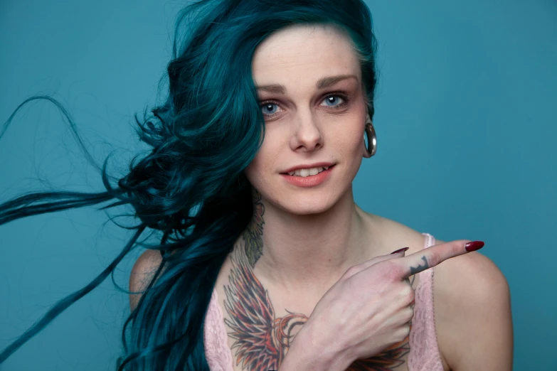 woman with tattoos holding a cigarette in hand