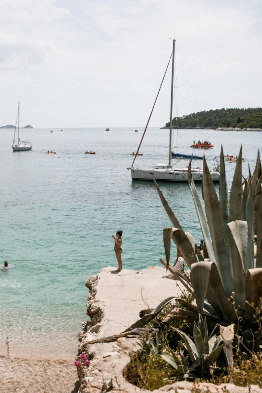 some people and small boats on the water