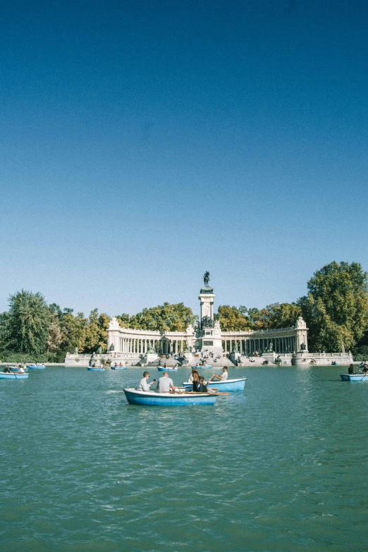 a bunch of small boats are going on the water