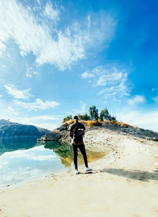 a man standing on the beach watching the water