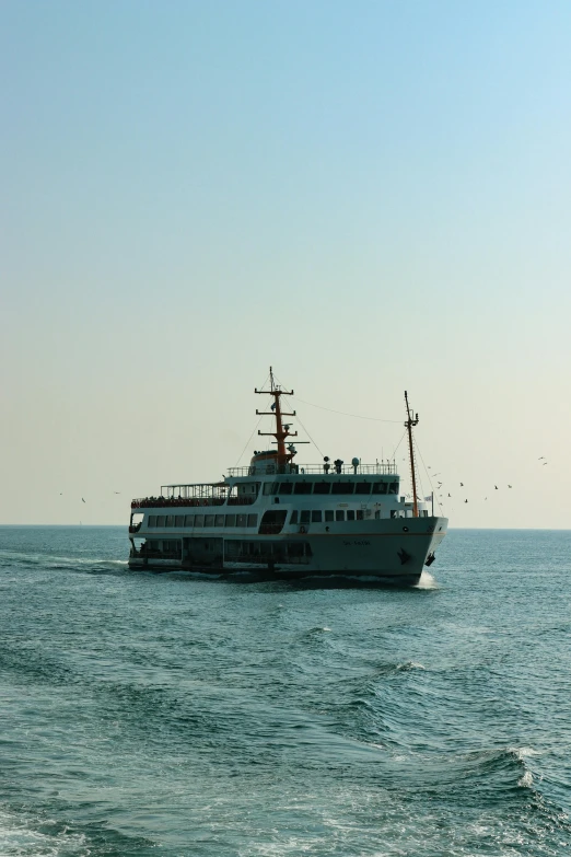 a large gray boat traveling across a body of water