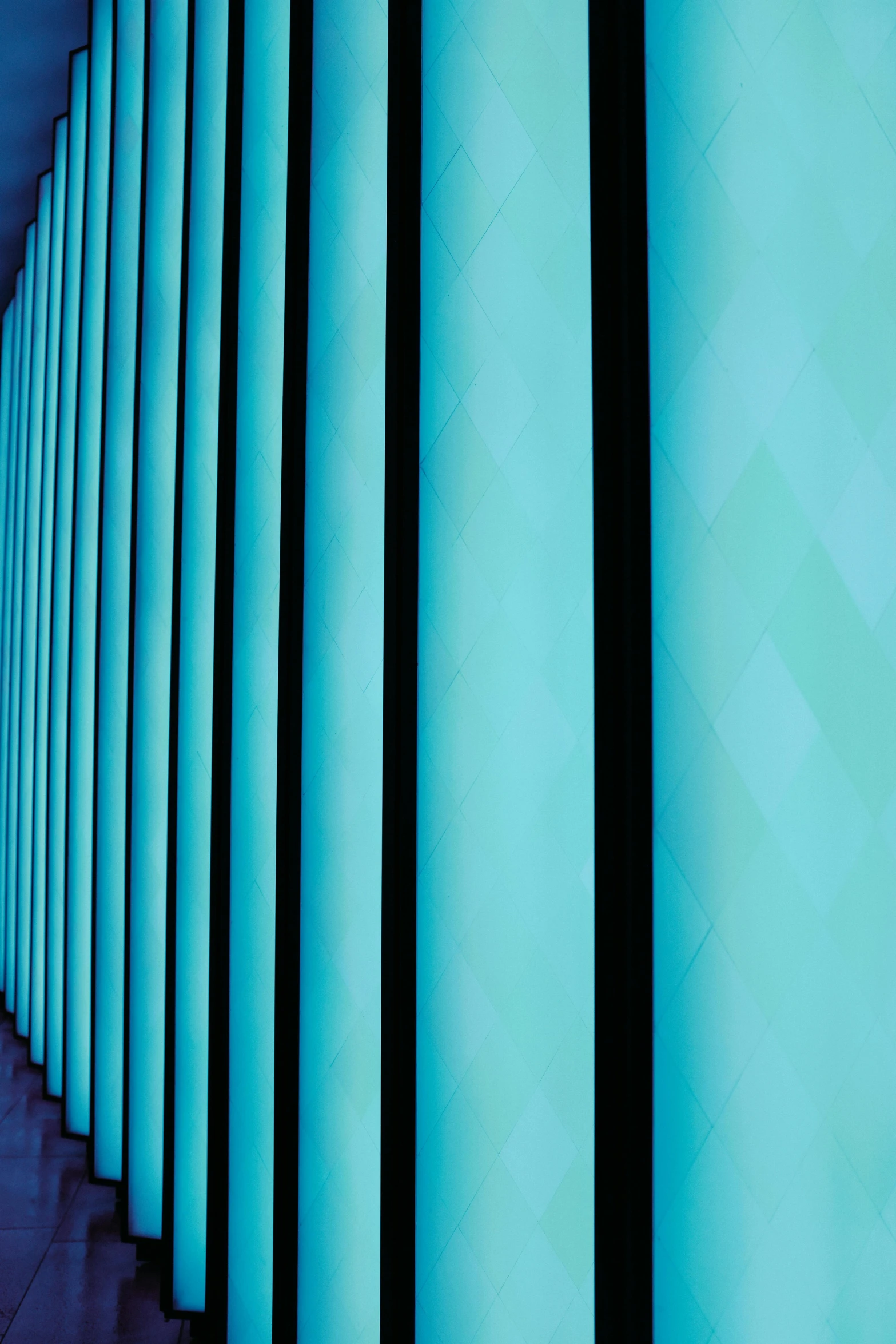 an abstract pograph with multiple stacks of vertical blinds in blue