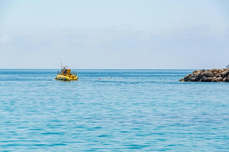 a small boat floating on top of a body of water