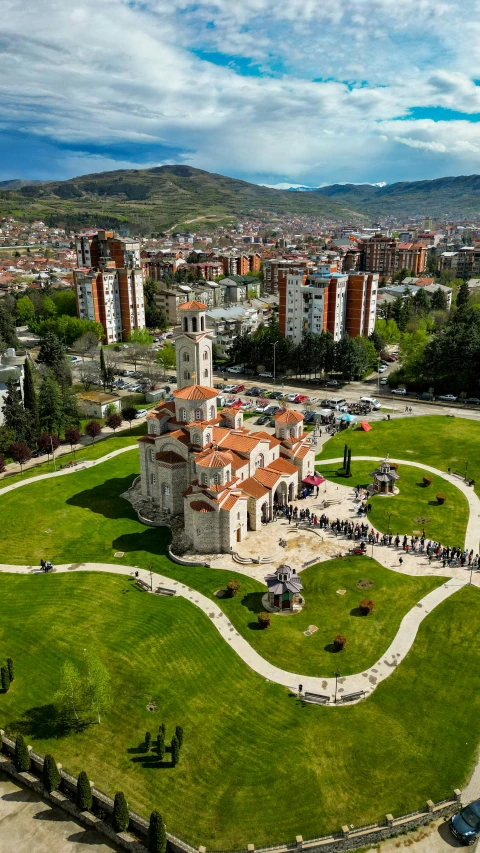 a large building in the middle of a green field