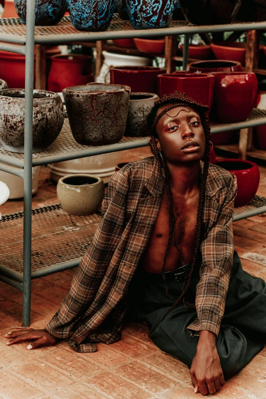 an indian man in a clothing shop sitting down