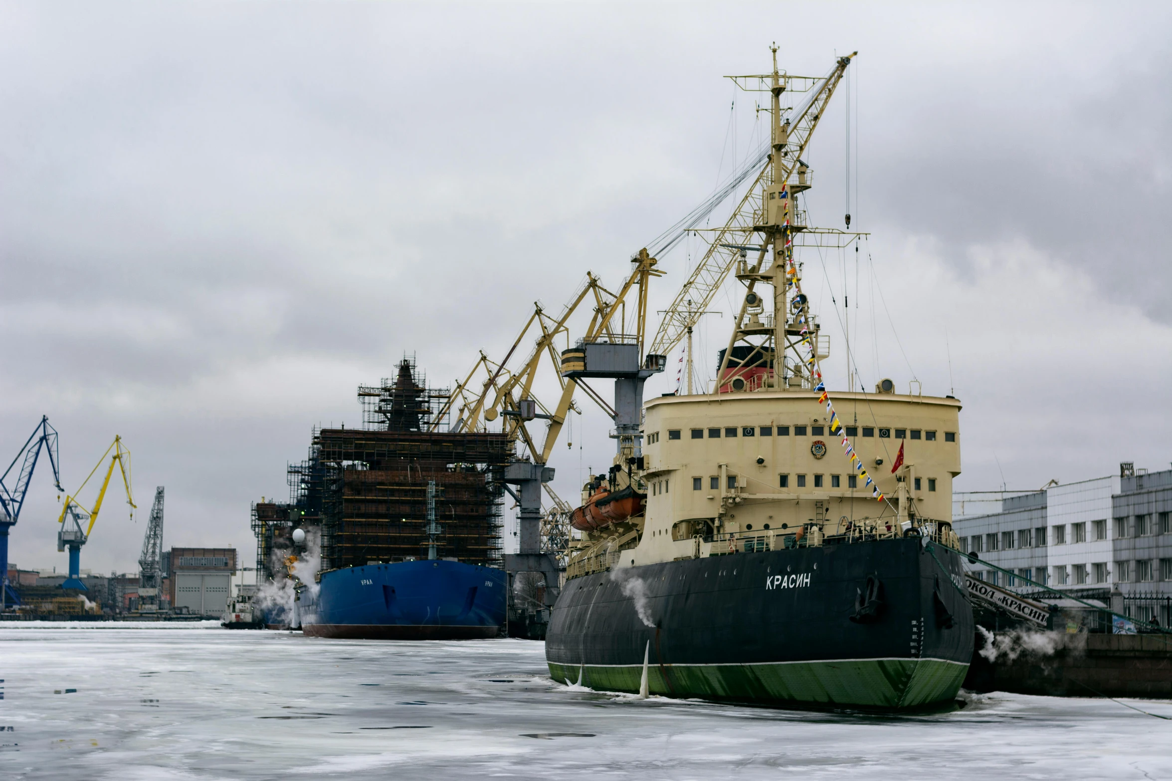 a ship in the water at dock with some other boats