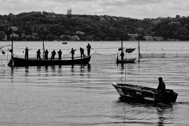 a man is standing on a boat out in the water