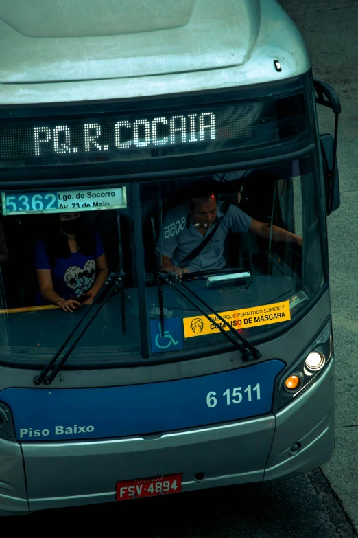 a bus parked at the side of the street with two passengers riding in it