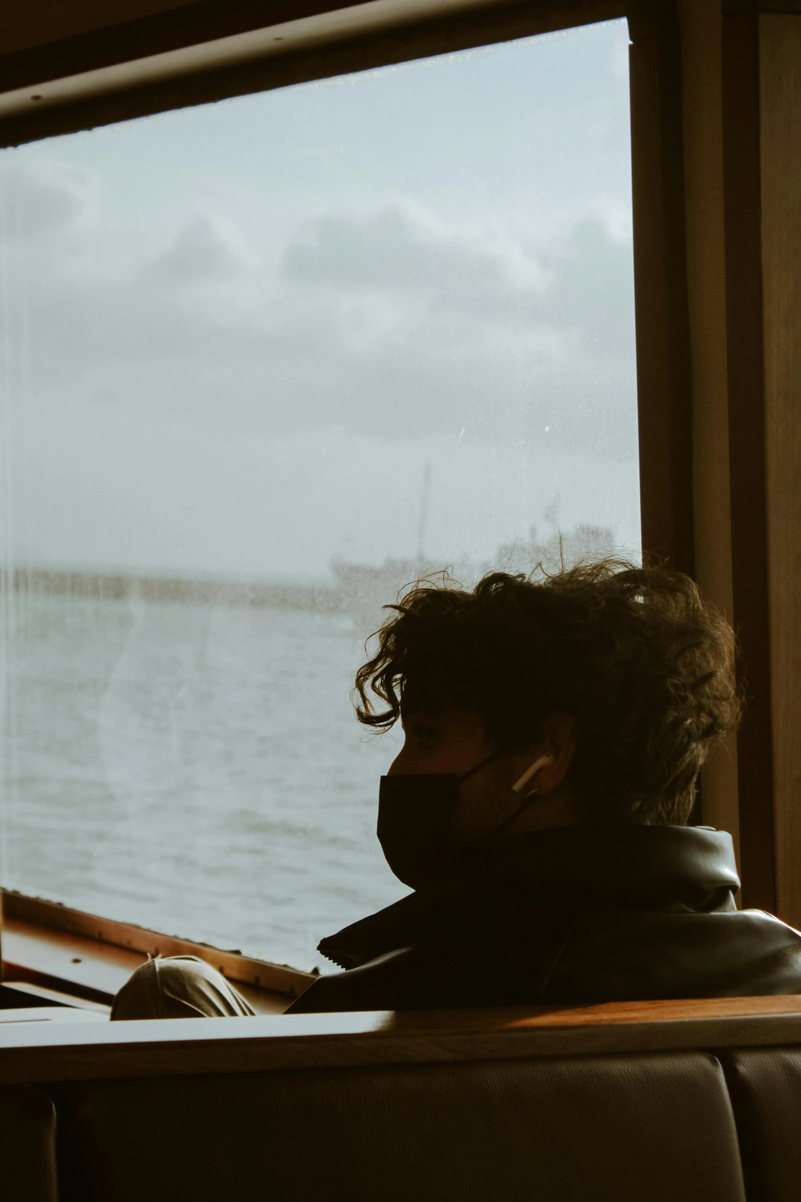 a person on a train next to a body of water