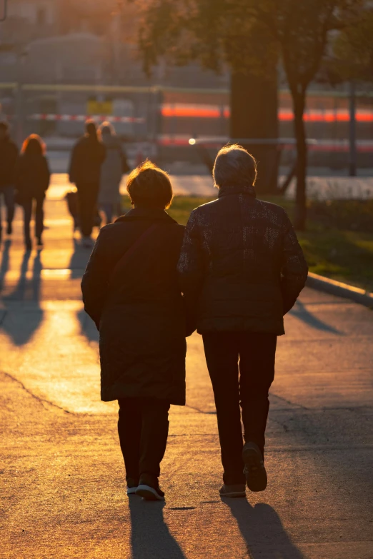 two people walking down a city street in winter