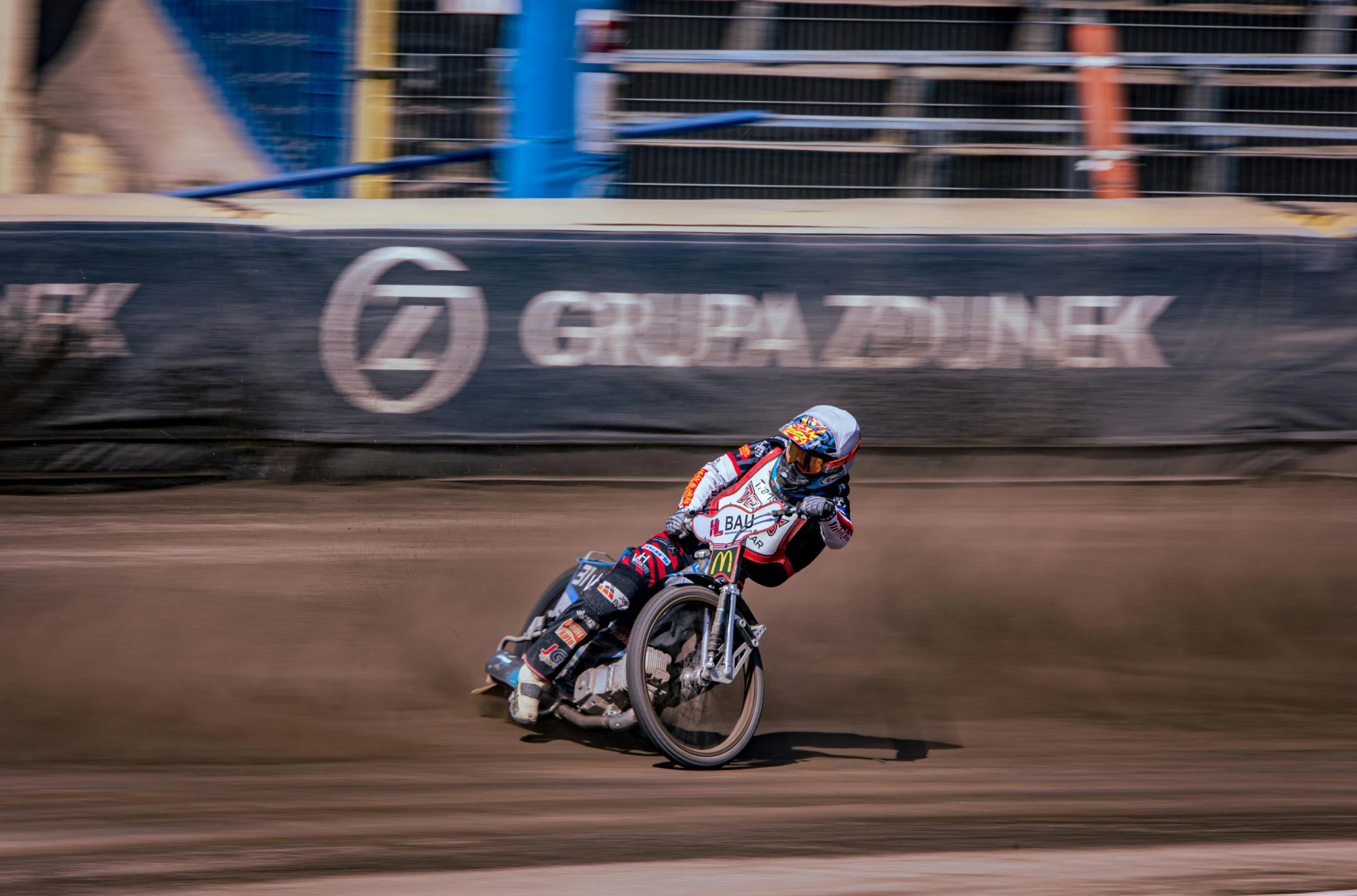 a man riding on the back of a dirt bike on top of a dirt field