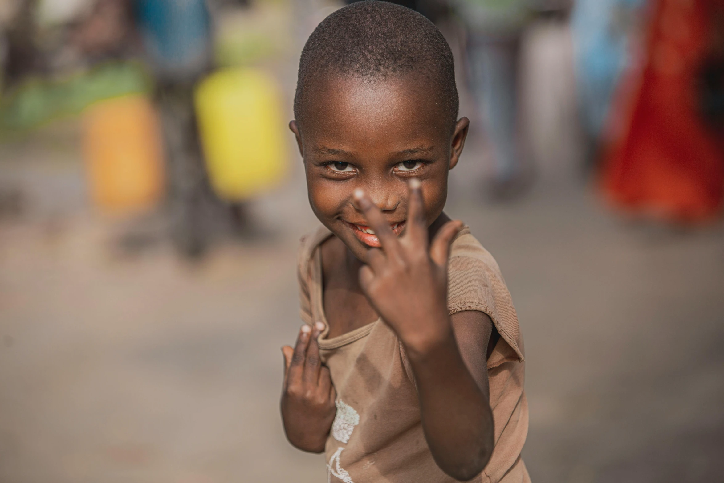 a boy is making the okay gesture with his hand