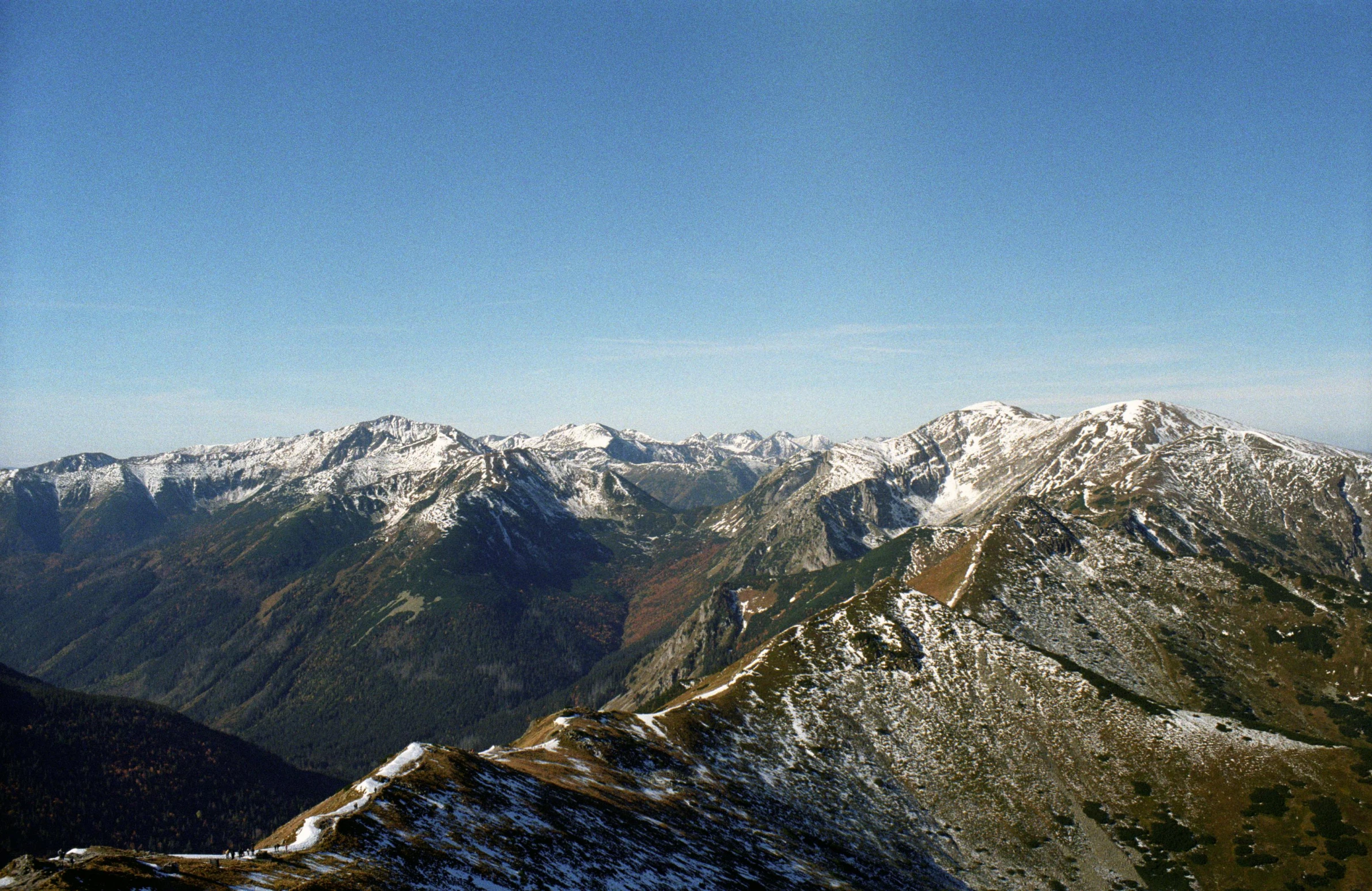 mountain range with snow on the tops and grass on the bottom