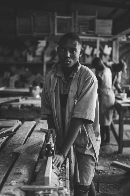 black and white pograph of man holding tool