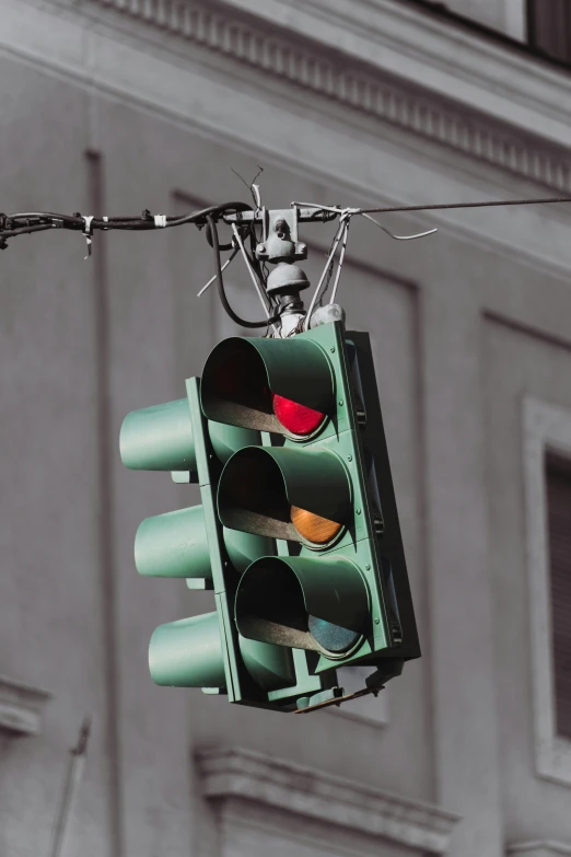 a red light hanging on a wire near a building