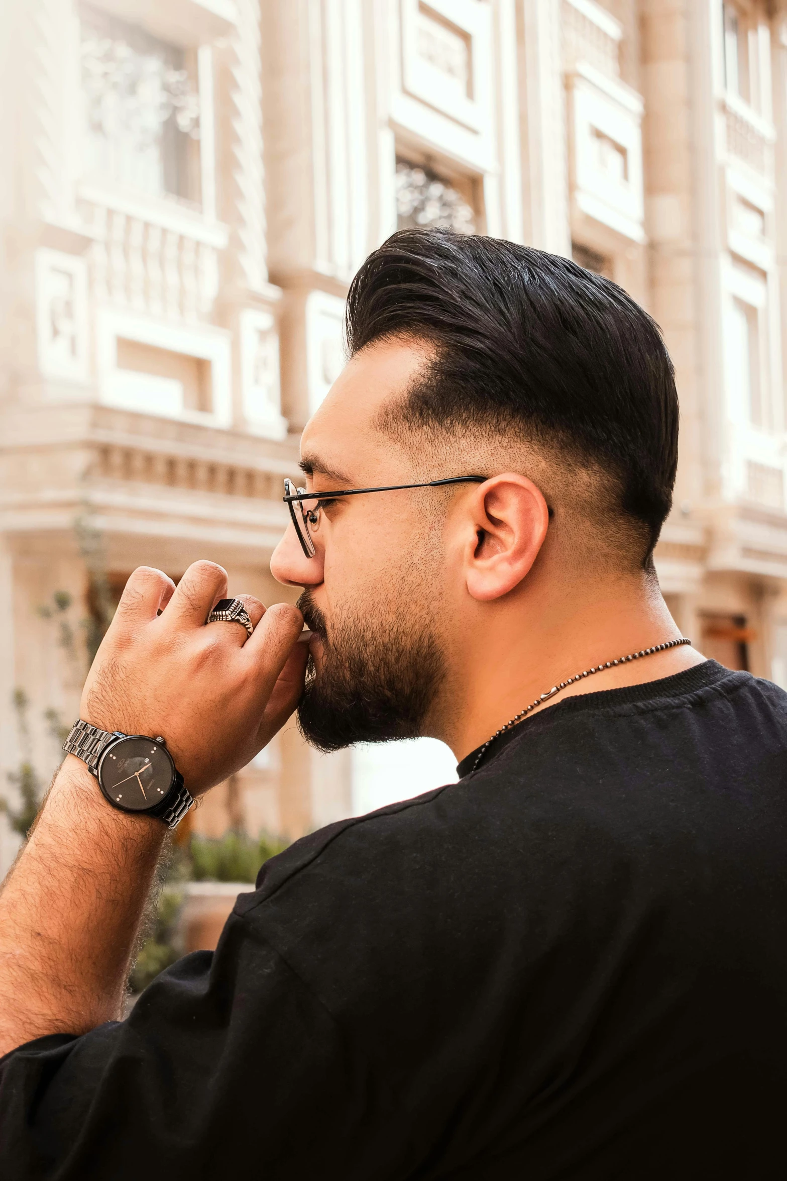 a man is smoking with a watch on his left hand