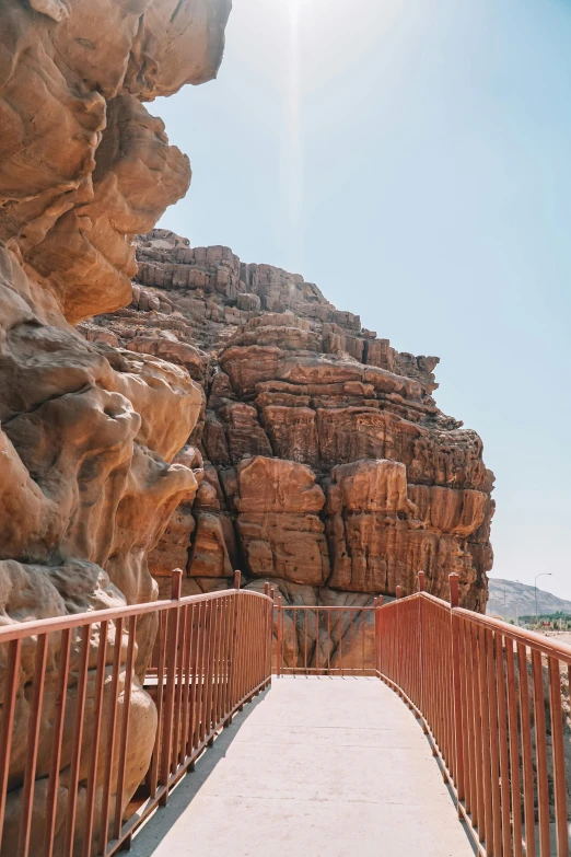 a wooden path leads into the large stone mountains