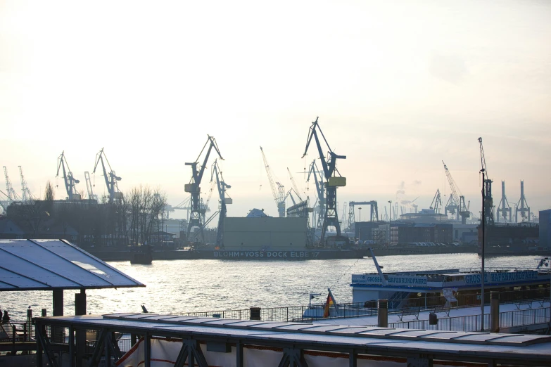 ships are docked at a dock with blue snow