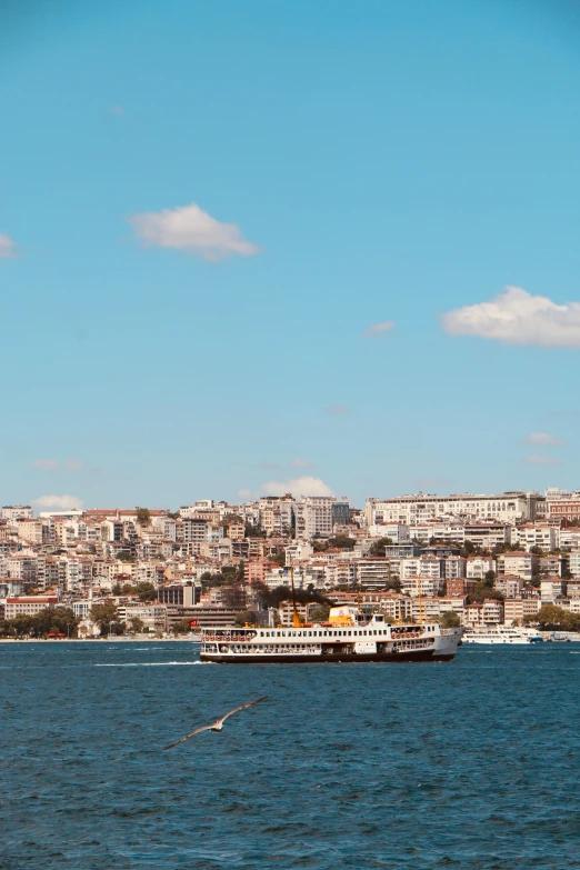 a boat is in the water with city on the side