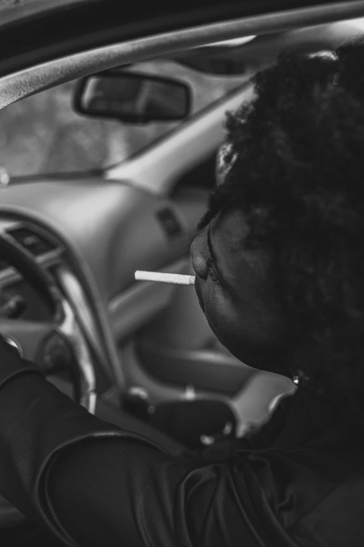 a person sitting in the driver seat of a car