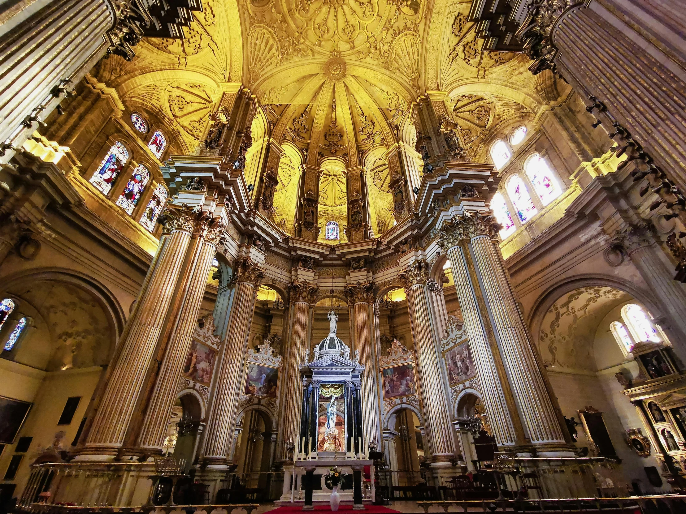 a large church with an elaborate altar with high ceilings