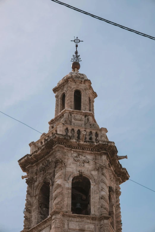 an old building with a cross on top and two clocks