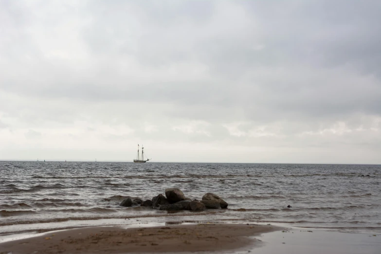 a sailboat sailing across a body of water