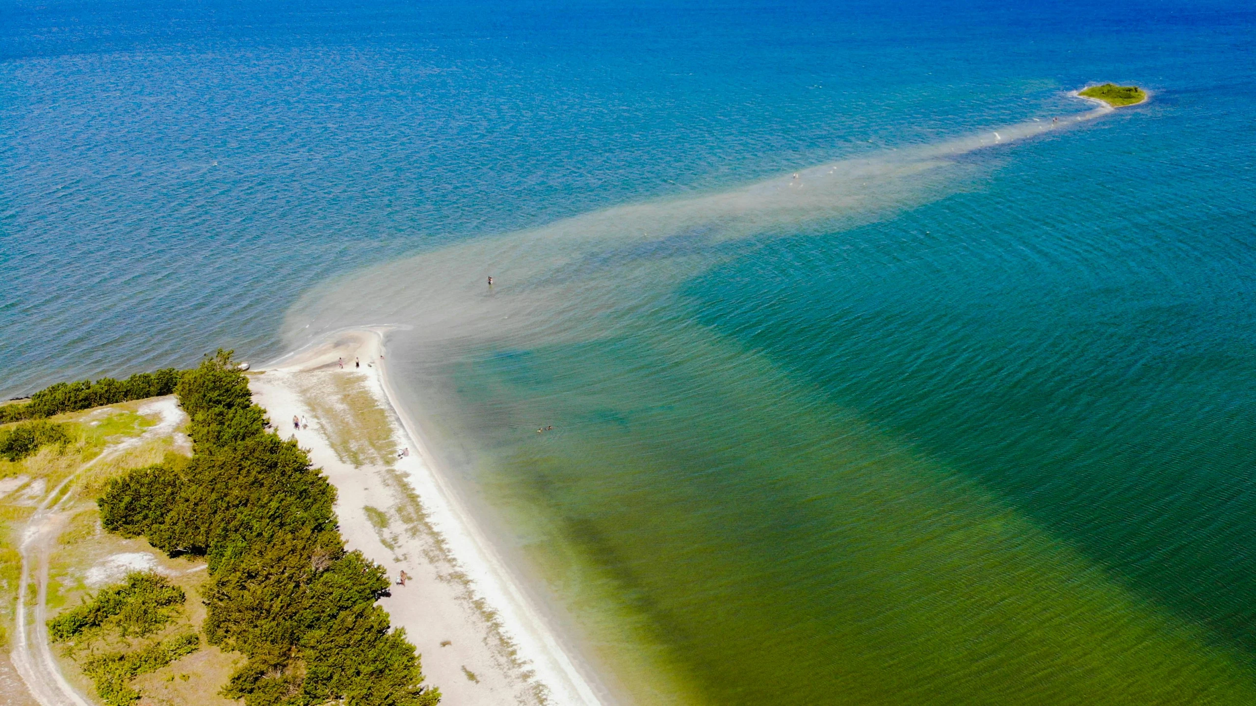 an aerial view of a lake next to the beach