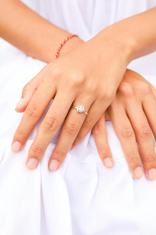 woman's hand resting on a mans shoulder with ring on top