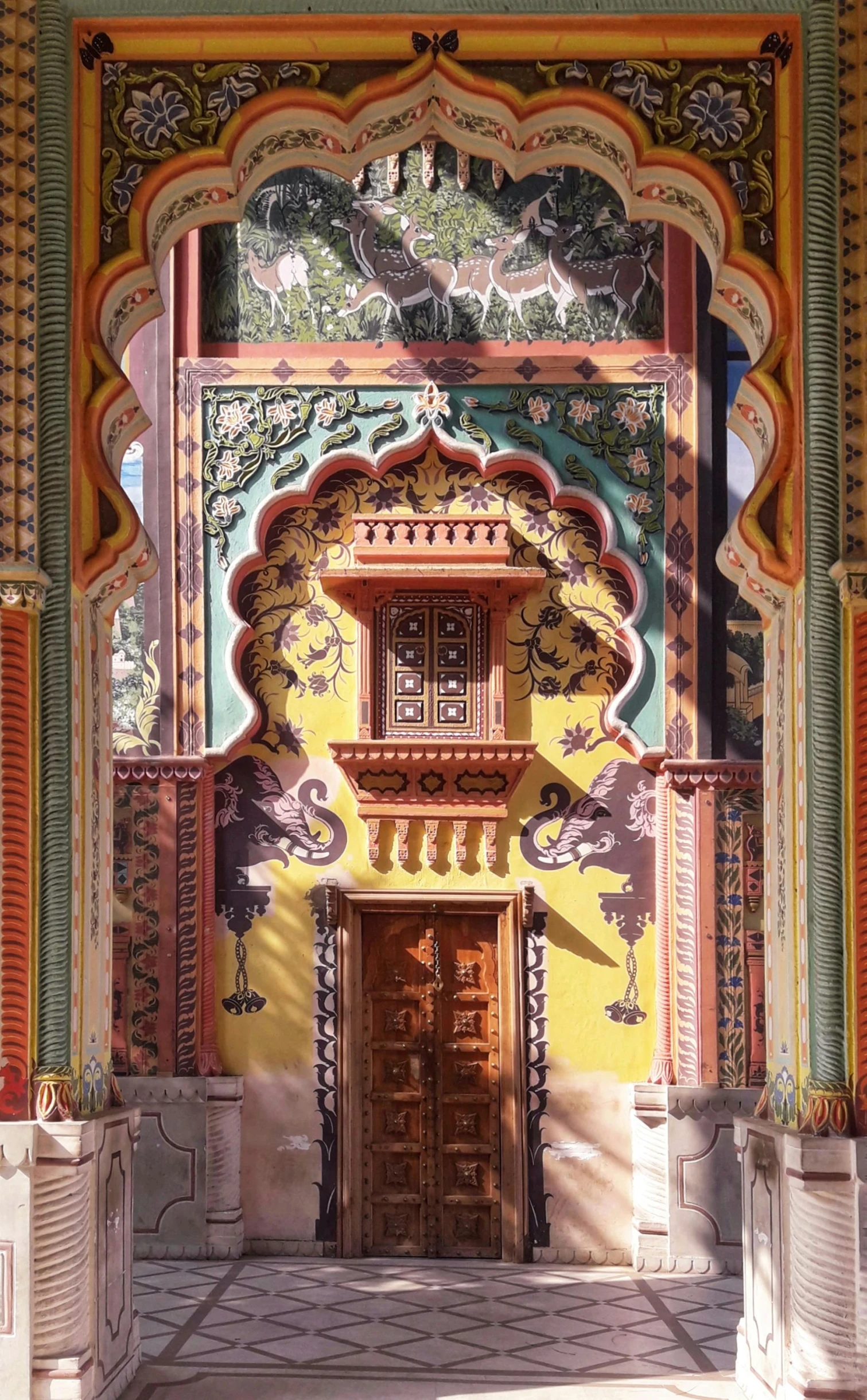 a doorway with ornate designs and windows in a building