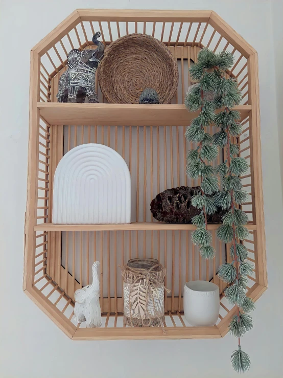 wicker shelf with a few dishes and greenery