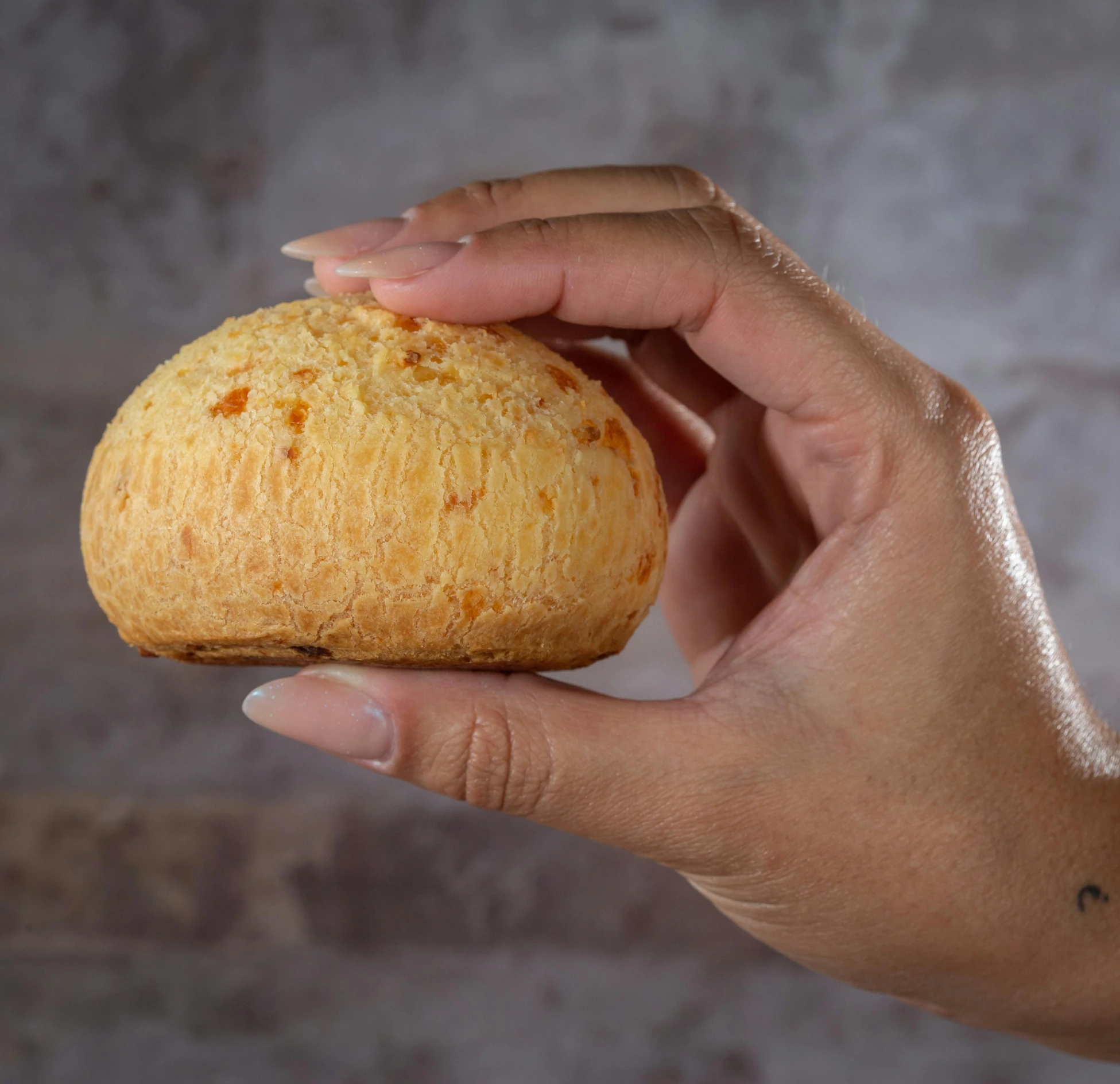 a hand holding a round object with various ingredients