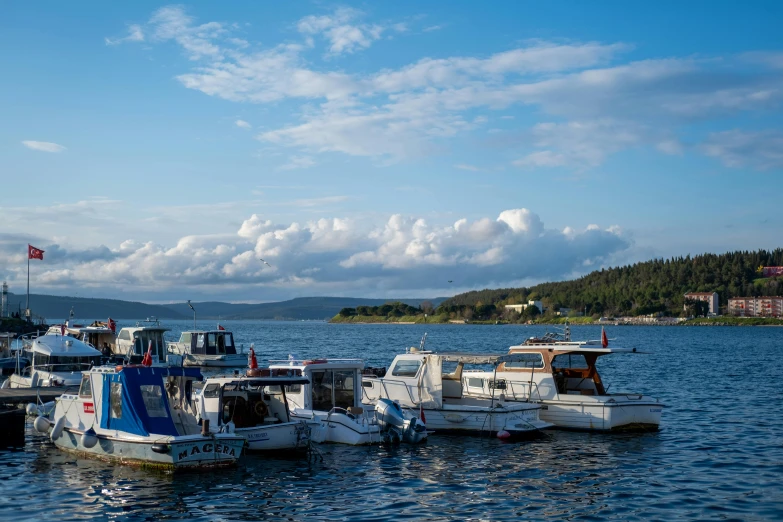 several small boats tied to a shore in water