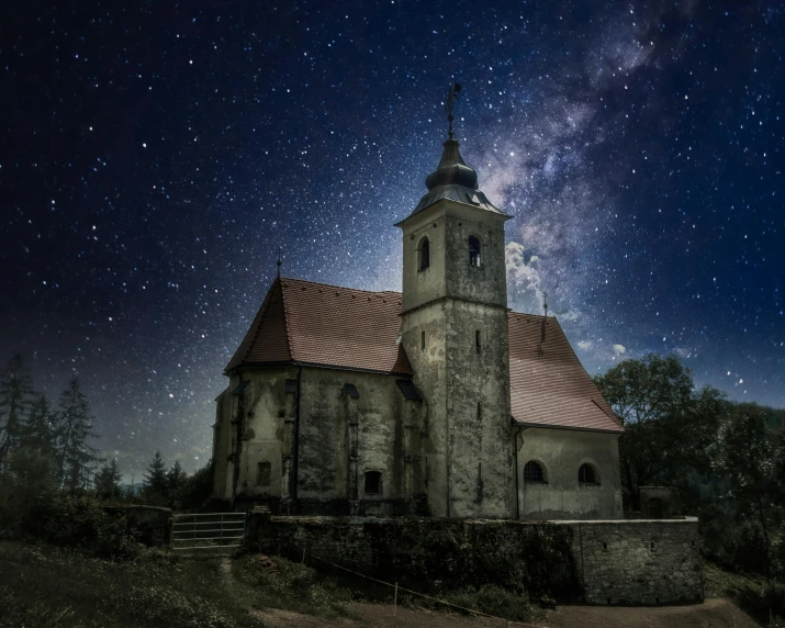 an old stone church with a red roof under the night sky