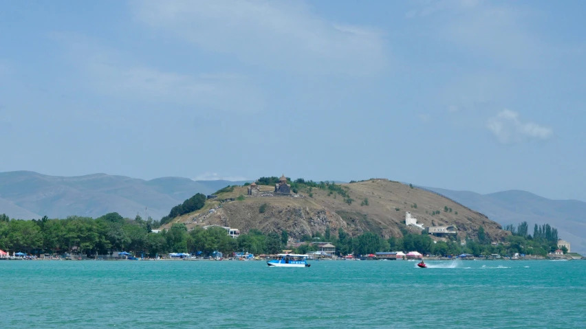 a scenic view of a mountain with boats in it